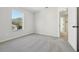 Bright bedroom with neutral carpet, a view of the neighborhood, and a closet at 1368 Falconwood Ct, Apopka, FL 32712