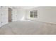 Bright bedroom featuring plush carpeting and neutral walls with a large window at 1368 Falconwood Ct, Apopka, FL 32712