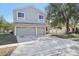 Exterior shot showing a well-maintained lawn and an attached two-car garage at 1368 Falconwood Ct, Apopka, FL 32712