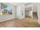 Bright, airy living room showcasing wood-look flooring and staircase to the second floor at 1368 Falconwood Ct, Apopka, FL 32712