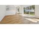 Open-concept living room with hardwood floors, large windows, and natural light at 1368 Falconwood Ct, Apopka, FL 32712
