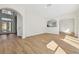 Spacious living room featuring light wood floors and arched design elements at 1368 Falconwood Ct, Apopka, FL 32712