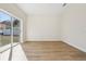 Bright living room features wood-look floors and a glass sliding door to the backyard at 1368 Falconwood Ct, Apopka, FL 32712