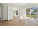 Open living room with wood-look floors and sliding glass doors to the backyard at 1368 Falconwood Ct, Apopka, FL 32712