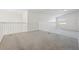 Open loft area with neutral carpet, white railings, and natural light from a window at 1368 Falconwood Ct, Apopka, FL 32712