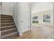 Carpeted staircase leading to the second floor, featuring an arched entryway at 1368 Falconwood Ct, Apopka, FL 32712
