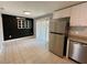 Cozy dining area with stainless steel refrigerator and sliding glass door at 1416 Braebury Dr, Leesburg, FL 34748