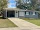 Charming single-story home with covered front porch and long driveway at 1416 Braebury Dr, Leesburg, FL 34748