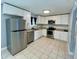 Modern kitchen features stainless steel appliances and white cabinetry at 1416 Braebury Dr, Leesburg, FL 34748