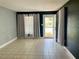 Bright and airy living room with tile floors and natural light at 1416 Braebury Dr, Leesburg, FL 34748