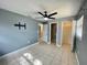 Inviting main bedroom featuring tiled floors, a ceiling fan, and ample space at 1416 Braebury Dr, Leesburg, FL 34748