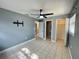 Inviting main bedroom featuring tiled floors, a ceiling fan, and ample space at 1416 Braebury Dr, Leesburg, FL 34748