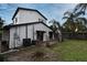 A home's backyard features a patio, lawn, palm trees, and perimeter wood fence at 1611 Chestnut Ave, Winter Park, FL 32789