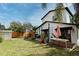 Landscaped backyard featuring a grass lawn, a brick patio, and a wooden fence offers privacy and space at 1611 Chestnut Ave, Winter Park, FL 32789