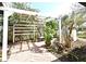 Cozy backyard with pergola creates an inviting outdoor space for relaxing and entertaining surrounded by lush landscape at 1611 Chestnut Ave, Winter Park, FL 32789