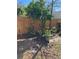 Landscaping features bushes and a tree in a mulched bed next to a wood perimeter fence at 1611 Chestnut Ave, Winter Park, FL 32789
