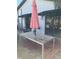 Backyard patio with dining set, brick pavers, and a patio umbrella for relaxing outdoor living at 1611 Chestnut Ave, Winter Park, FL 32789