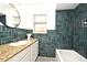 Bathroom featuring a modern vanity, granite countertop, and blue tile at 1611 Chestnut Ave, Winter Park, FL 32789