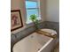 Close-up of a modern soaking tub with accent tile wall and decor at 1611 Chestnut Ave, Winter Park, FL 32789