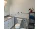 Bathroom featuring vanity, blue and white patterned tile accent wall, and black metal shelving at 1611 Chestnut Ave, Winter Park, FL 32789