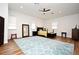 Bedroom with a modern ceiling fan, large windows, and wood-look floors at 1611 Chestnut Ave, Winter Park, FL 32789
