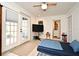 Cozy bedroom featuring a ceiling fan, doors to the outside, and an attached bathroom at 1611 Chestnut Ave, Winter Park, FL 32789