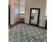 Cozy bedroom with a mirror, a red stool, and a window at 1611 Chestnut Ave, Winter Park, FL 32789
