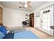 Bedroom featuring a ceiling fan, doors to the outside, and an attached bathroom at 1611 Chestnut Ave, Winter Park, FL 32789