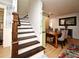 Home entryway with dark wood stairs and view of the dining area at 1611 Chestnut Ave, Winter Park, FL 32789