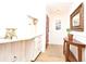 Inviting entryway boasts wood-look floors, a red front door, coat rack with storage and a wooden accent table at 1611 Chestnut Ave, Winter Park, FL 32789