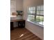 Bright home office space with natural light, wood floors, desk, and floating shelves at 1611 Chestnut Ave, Winter Park, FL 32789