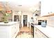 Bright kitchen featuring stainless steel appliances, a stylish island, and a door to the laundry room at 1611 Chestnut Ave, Winter Park, FL 32789