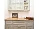 A kitchen cabinet with glass doors showcases decorative dishware and a granite countertop at 1611 Chestnut Ave, Winter Park, FL 32789