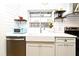 Bright kitchen featuring subway tile backsplash, open shelving and stainless steel appliances at 1611 Chestnut Ave, Winter Park, FL 32789
