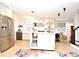 Open concept kitchen boasts white cabinets, island, and stainless steel appliances at 1611 Chestnut Ave, Winter Park, FL 32789