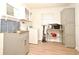 Well-lit laundry room featuring modern appliances, ample storage, and stylish blue tile backsplash at 1611 Chestnut Ave, Winter Park, FL 32789
