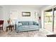 Inviting living room featuring a plush blue sofa, natural light, and backyard access at 1611 Chestnut Ave, Winter Park, FL 32789