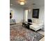 Bright living room with hardwood floors, modern furnishings, and a large area rug offering stylish comfort at 1611 Chestnut Ave, Winter Park, FL 32789