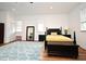 Spacious main bedroom features ample natural light, hardwood floors, and a large stylish area rug at 1611 Chestnut Ave, Winter Park, FL 32789