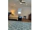 Bright bedroom with wood floors, ceiling fan, and a patterned blue area rug at 1611 Chestnut Ave, Winter Park, FL 32789