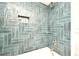 Stylish shower featuring blue tile, built-in niche, and modern fixtures at 1611 Chestnut Ave, Winter Park, FL 32789