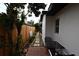 Narrow side yard features a brick paver patio, stepping stones, and a black metal patio set at 1611 Chestnut Ave, Winter Park, FL 32789