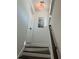 Staircase with dark wood treads and white risers leading upstairs with natural light at 1611 Chestnut Ave, Winter Park, FL 32789