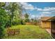 Spacious backyard with a wooden fence, lush green grass, and a cozy outdoor seating area at 22 Sweetwater Creek Cir, Oviedo, FL 32765