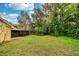The property showcases a lush backyard with mature trees, a screened-in patio, and an outdoor seating area at 22 Sweetwater Creek Cir, Oviedo, FL 32765