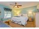 Calming bedroom with a ceiling fan, comfy bedding, and a window with decorative drapes at 22 Sweetwater Creek Cir, Oviedo, FL 32765
