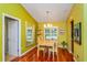 Cozy dining area featuring hardwood floors, chandelier, and plenty of natural light at 22 Sweetwater Creek Cir, Oviedo, FL 32765