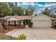 Charming single-story home with a two-car garage, complemented by a lovely pergola-covered seating area and manicured front yard at 22 Sweetwater Creek Cir, Oviedo, FL 32765