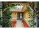Inviting front entrance framed by lush greenery and manicured landscaping, leading to a charming, well-maintained home at 22 Sweetwater Creek Cir, Oviedo, FL 32765