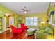 Cozy living room with stylish decor, featuring vibrant armchairs and hardwood flooring at 22 Sweetwater Creek Cir, Oviedo, FL 32765